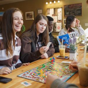 Students play a board game