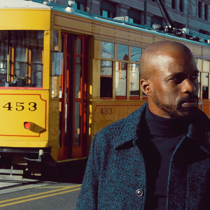 B. Brian Foster portrait with yellow trolley in the background