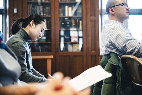 A woman listens to Peter Hessler lead a workshop