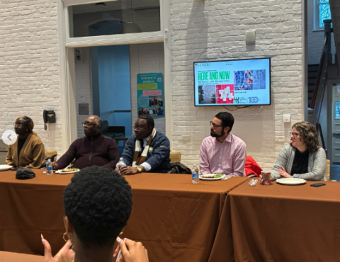 Guests sit at a table for the end of the year Africana Studies celebration