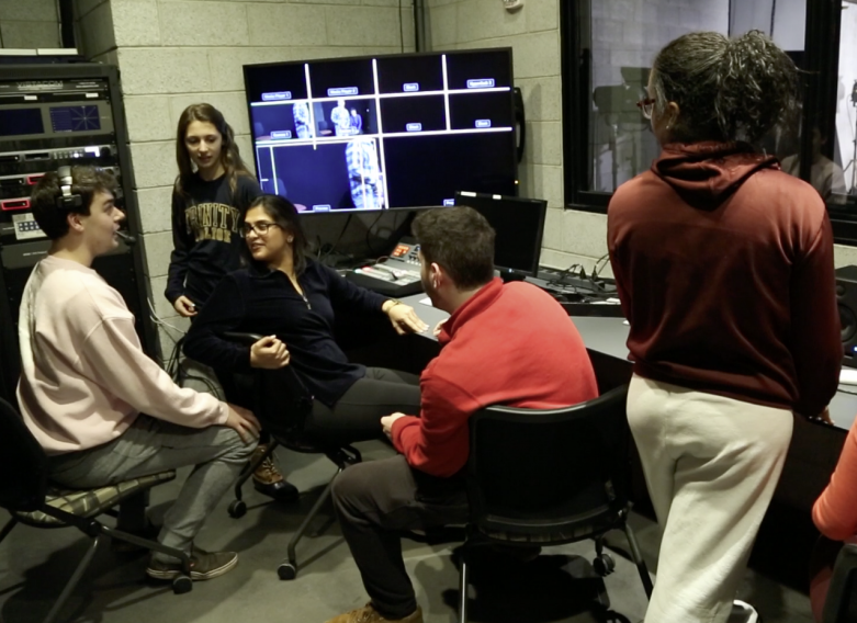 Students editing video content in a small room