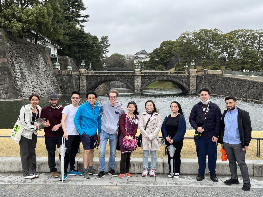 Students stand in front of a bridge in Japan