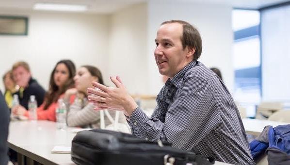 Jeff Helfin speaks sitting at a table