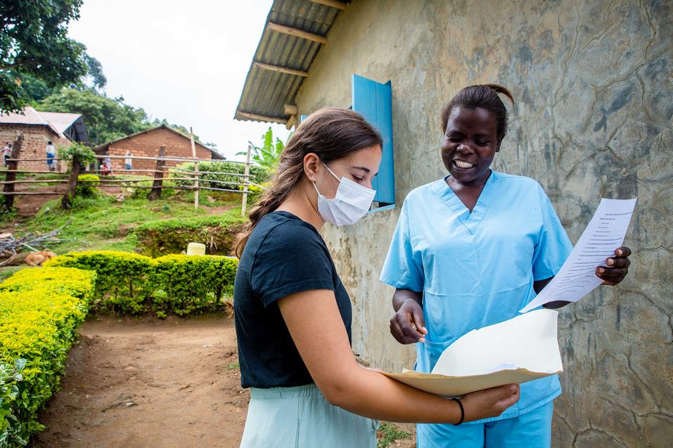 Mia Zibello wears a mask and works with healthcare worker Marium at Zion Medical Clinic.