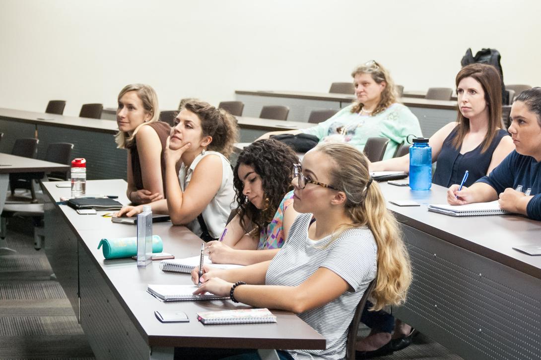 Students sit in a classroom taking notes