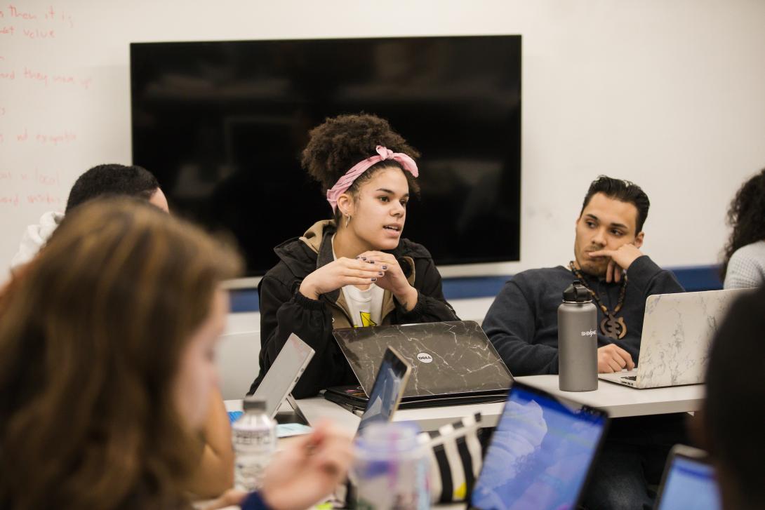 A student responds during a discussion in a classroom