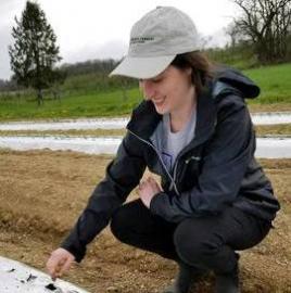 Margaret Wilson plants seeds on a farm