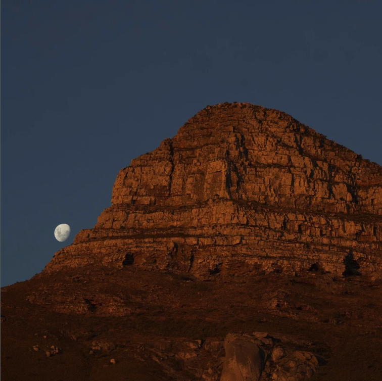 A moon rises over a mountain in South Africa