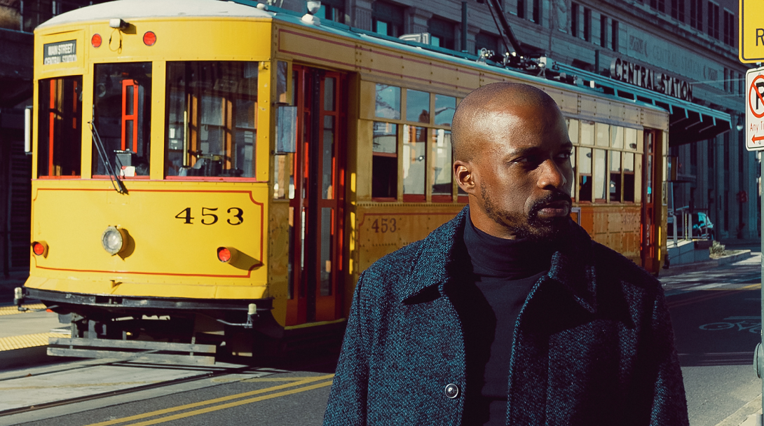 B. Brian Foster portrait with yellow trolley in the background